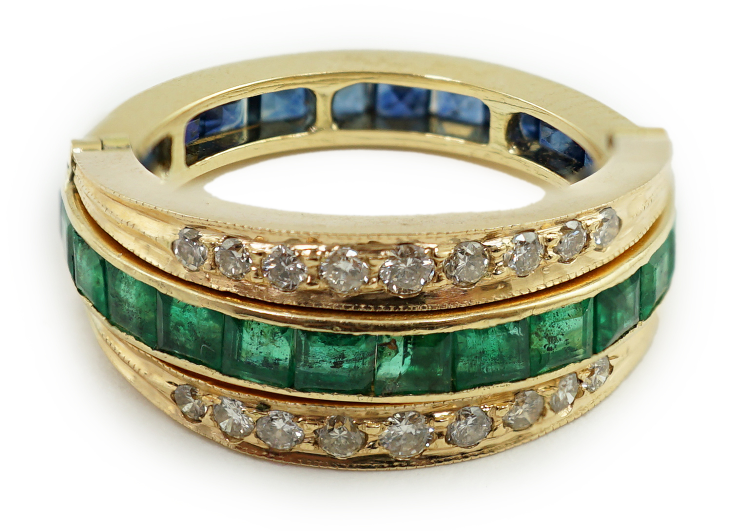 A recent gold, emerald, sapphire and diamond set triple band swivelling eternity ring